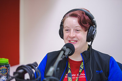 Mallory Spencer smiling at a podcast recording